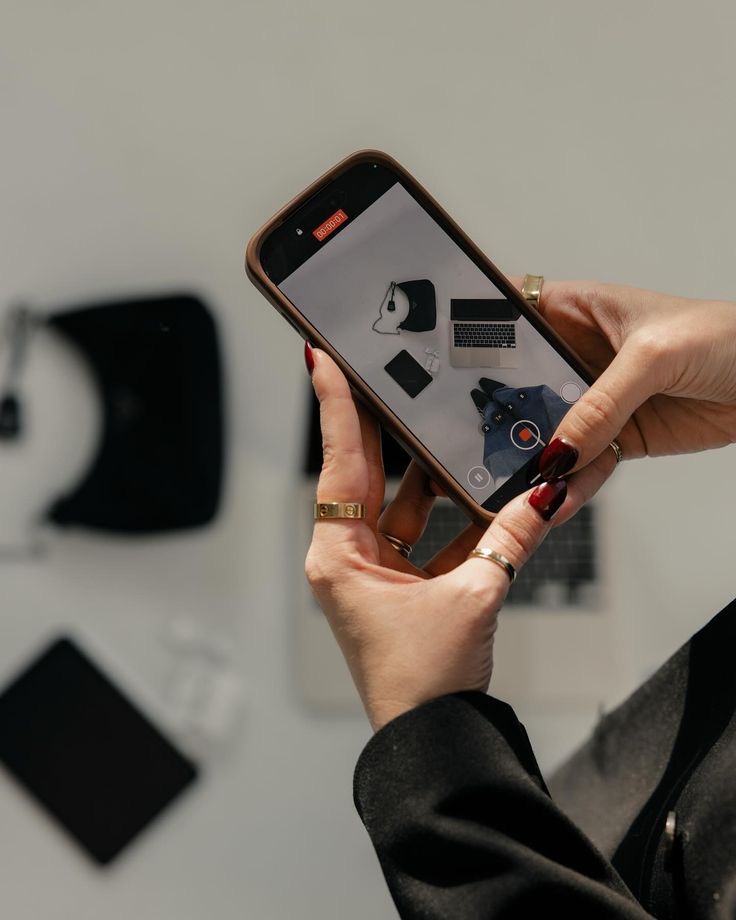 Hands reviewing visual content on a phone